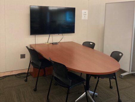 Table with chairs and TV screen. Click on this picture to reserve this space.