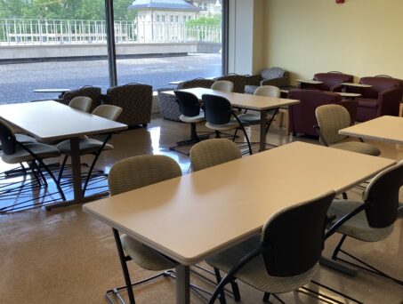 Room full of tables and chairs. Click on this picture to reserve this room.